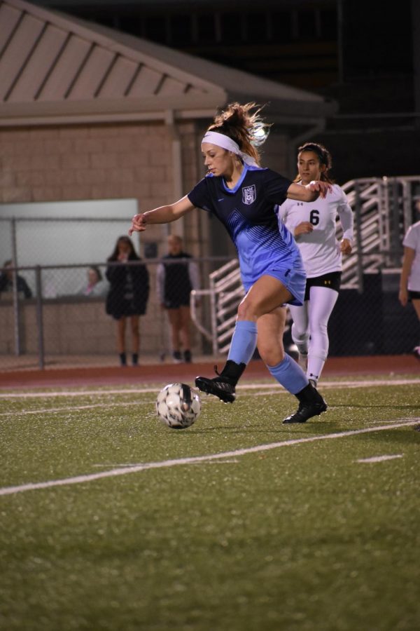 A Shot in the dark \\ Sophomore Tristyn Gaida pushes the ball up the field in hopes of her team scoring. Gaida has been on varsity for two years and plays defensive mid. Varsity won 3-0 against Denison High School Feb. 20. 