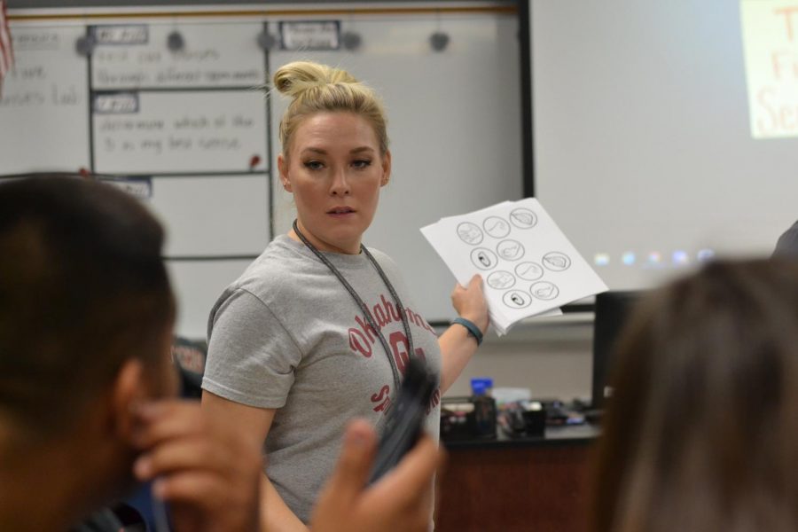 Support in all the right places // Showing some love, new teacher from Garland ISD, Mrs. Amie Torres high fives senior Quincy Jackson during a lesson about the observations in forensics. 