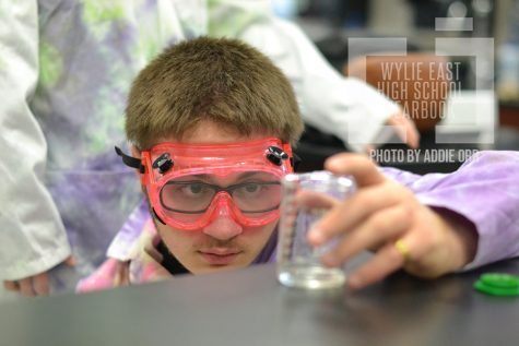 Mindful Measurement \\ Checking the amount of solution in his beaker, sophomore Andrew O’Grady participates in a lab for Mr. Vito Peri’s sixth period pre-AP chemistry class Jan. 25. 
