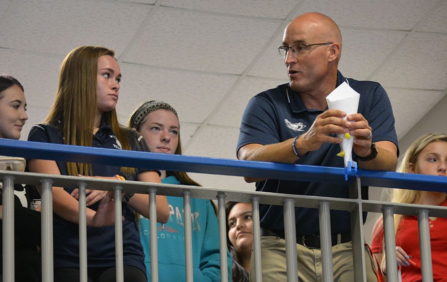 Onlookers \\ Teaching to his third period physics class, Coach Heath Andrews demonstrates an egg drop experiment. Coach Andrews has 32 students in his third period class.
