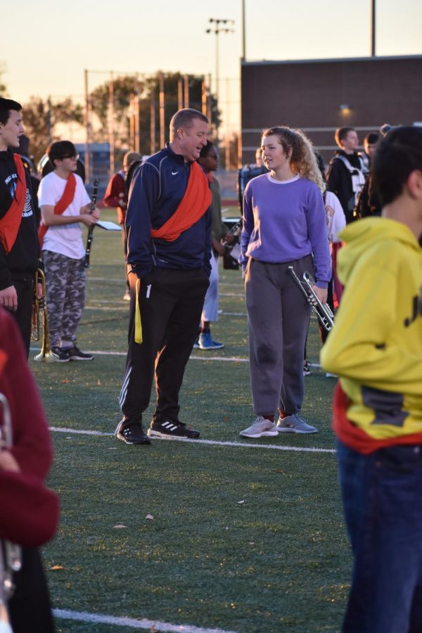 Like father like daughter / /Senior Maizy True teaches her father, Coach True, the drill in Conquered during the annual Marchaspot. 
