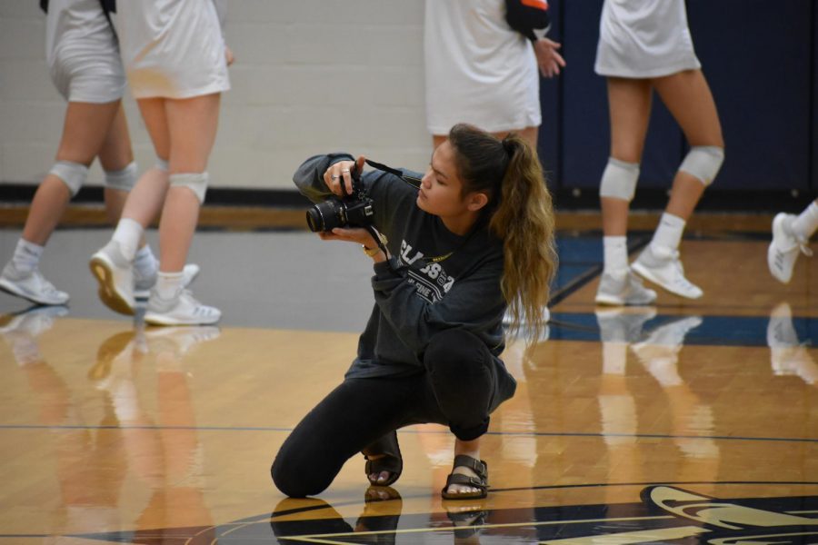 Triple threat \\ Senior Maddie Smith takes photos of a varsity volleyball game. She shares her work with The Wylie News, the school newspaper and yearbook because she is on all three staffs. 
