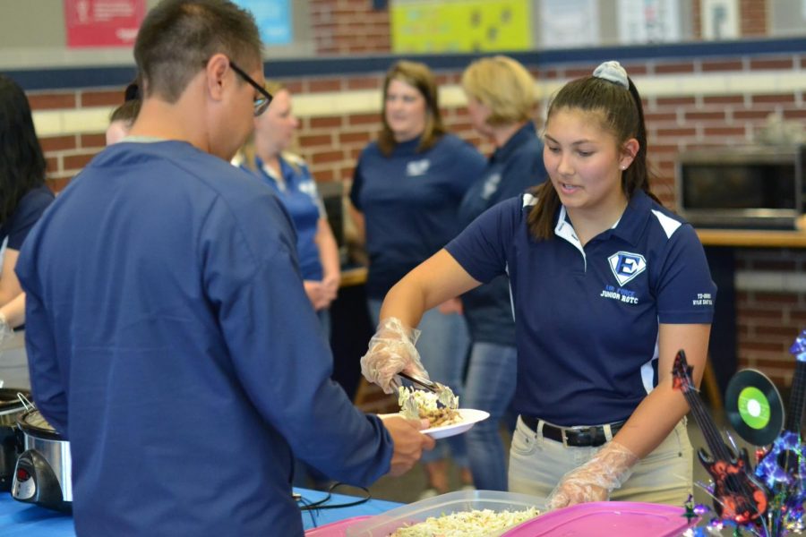 Food for thought // Junior Viviane Dao serves freshman cadets and their parents during the annual First Year Dinner Sept. 28. This event, along with many others, helped the unit earn the Silver Star Community Service with Excellence Award.