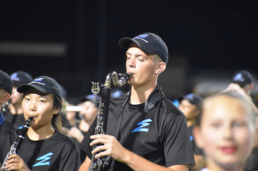 Fight to play \\ Senior clarinet player Aeyon Ko and bass clarinet player Wylie Dunham play the fight song during the pregame show in Mount Pleasant