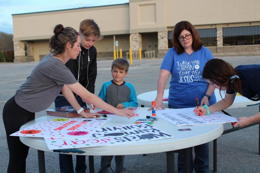 Coming together // Making posters and signs, students and adults gathered at the old Brookshires in Wylie to peacefully protest bullying in honor of Riley Russell.