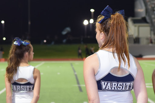 Standing on the sidelines  \\ Senior varsity cheerleader Karaline Klakamp watches the football players play as she thinks about the next cheer to encourage the boys Sept. 27 at a game against West Mesquite. No matter their grade, all cheerleaders should have a shot at being on the varsity team.
