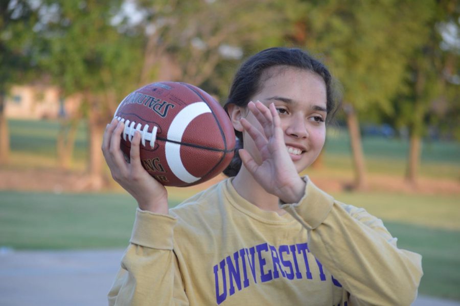 All smiles around here \\ After picking up a lonely football on the field, senior Genesis Monterroso engages in a game of catch with her StuCo members. Monterroso was the brains behind the event with her new social committee in the organization. 
