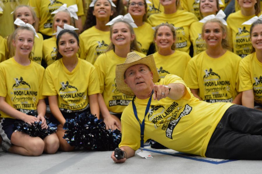Golden tooth \\ Principal Mr. Mike Williams shows off his “gold out” attire for group photo at the end of the pep rally. The yellow t-shirts were sold for $10, $7 of each sale went back to support childhood cancer research.