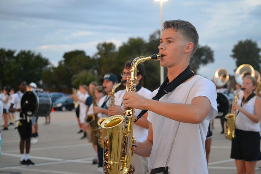 Saxy tunes \\ Practicing early in the morning on the marching band parking lot, senior Trace Delacerda prepares for the first competition of the season. The band’s show is Massive this year. Everyone has some point where they want to quit, but when you perform, it all pays off, Delacerda said.