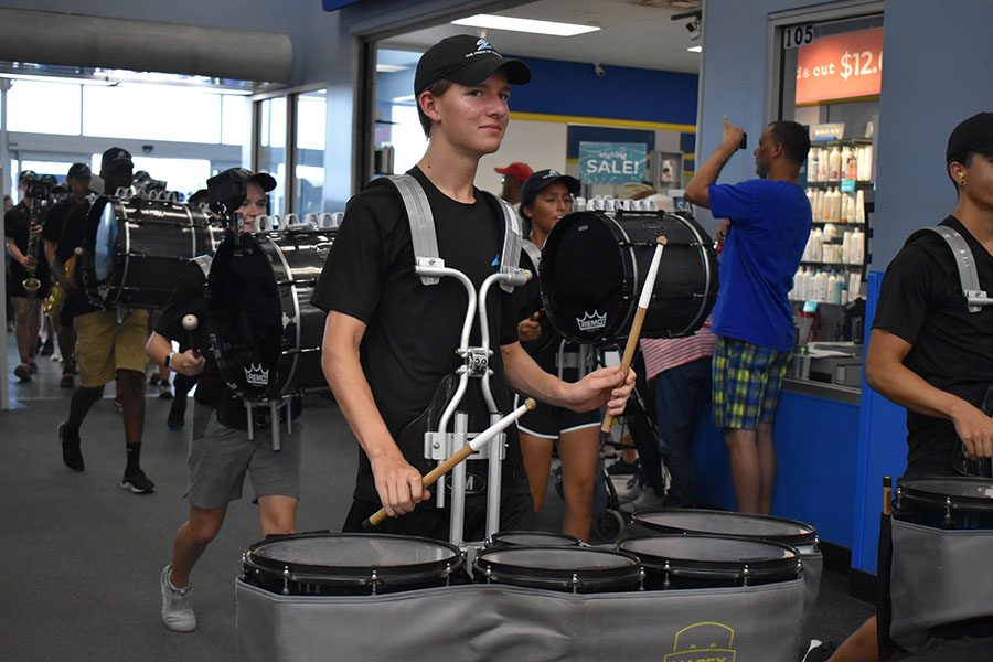 Drumming up support \ Entering the Wylie Walmart, senior percussionist Luke Enns plays the school fight song before ending the annual March-a-thon Sept. 7.