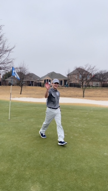 One shot, one hole \\ Sophomore Carson Tittle grabs his hole-in-one ball from the hole to celebrate. He played with the junior varsity boys team at the RHS Big 4 competition at Waterview Golf Course Feb. 8. “I have not gotten a hole in one at a competition before. In fact, this was my first hole in one,” Tittle said.