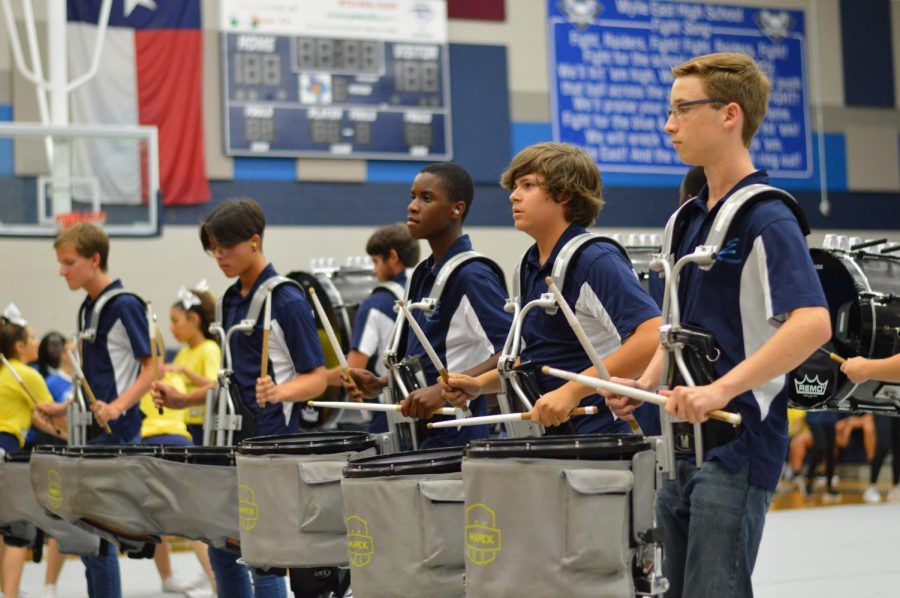 On a roll \\ Facing juniors and seniors, drumline performs a piece titled “Spice Mon.” The drumline took center stage at the rally, hyping up the student body and football team before they opened their season against North Forney. “It was incredibly gratifying to show off our hard work for an audience,” sophomore snare player Daniel Cline said.