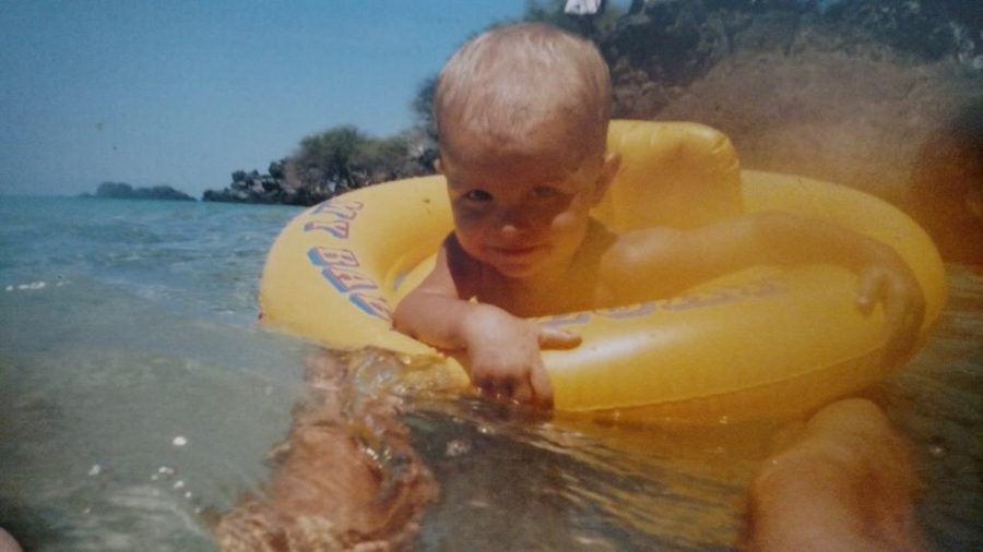 Enjoying his favorite memory of living in Hawaii, young Keoni Hernandez floats around a beach in his old home town. He moved to the states in seventh grade.