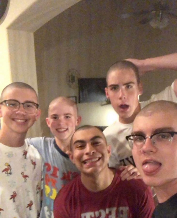 Snip snip \\ Posing their new looks, junior Hayze Gore (second from the left) and his four friends enjoy the feel of the fresh air on their heads after a new shave in support for their friend battling cancer.
