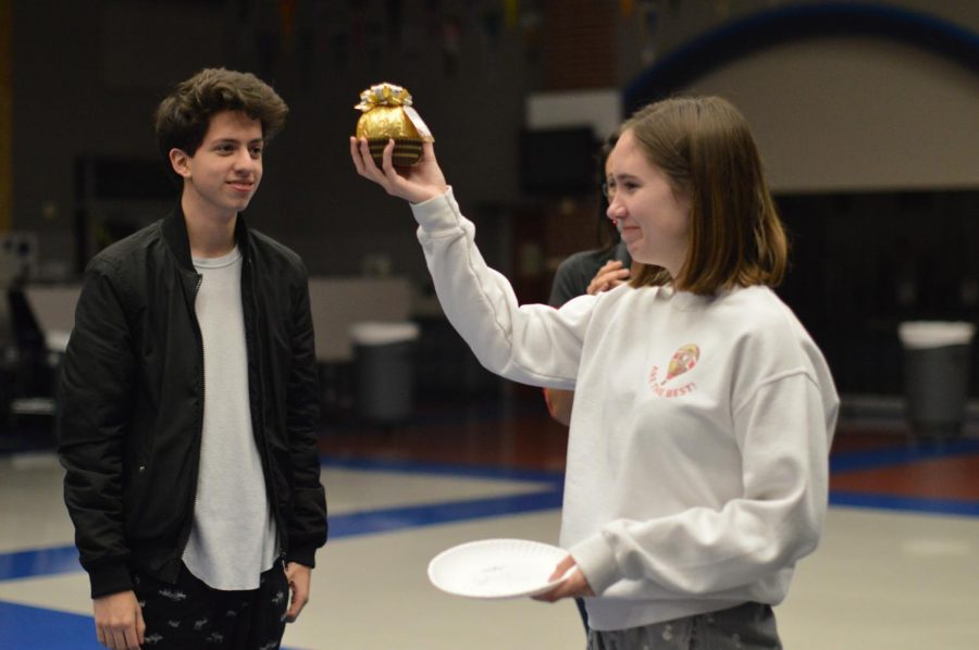 Golden \\ Winning the plate contest, senior Delaney Crane accepts the golden egg of Christmas. “Choir is a safe place where I can go whenever Im feeling stressed or overwhelmed,” Crane said. “Making music with choir warms my heart and gives me the inspiration to bring more passion and heart to my everyday life, and to always see the beauty in things.”
