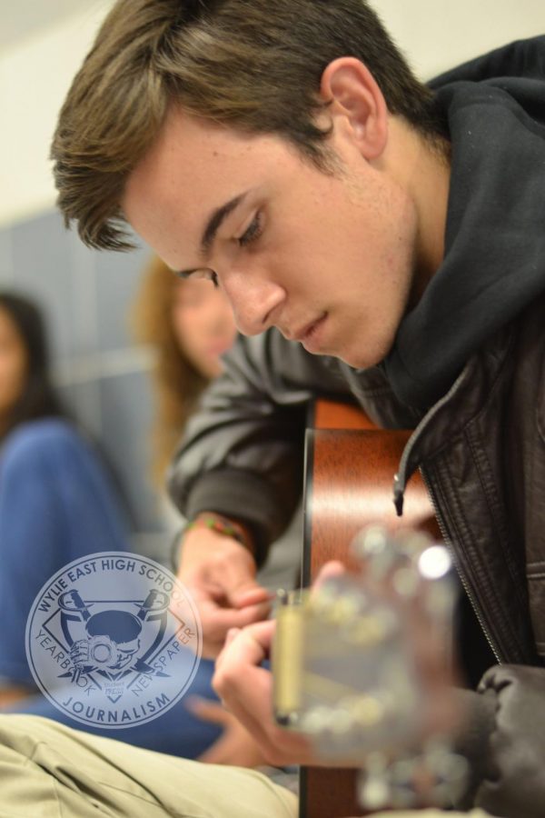 Tuned up \\ Practicing his guitar for digital audio tech, junior Saverio Cimino creates a tune in the 400 hall. Digital audio tech, taught by Mr. Turner, allows students to pursue their musical passions.