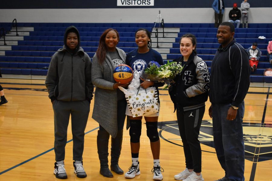 Record setter \ \ Before a game, junior Akasha Davis, celebrates her accomplishment of getting 1000 points throughout her varsity career. Davis has played three years on the girls varsity basketball team. The team played Lovejoy High school Jan.11 and won 65-39.