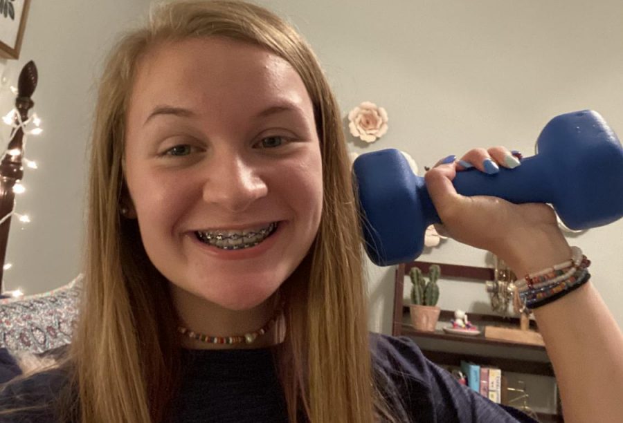 Healthy home \ Sophomore Ryah Hill uses a dumbell to show different ways students can exercise and stay healthy from their home during the Covid-19 pandemic.