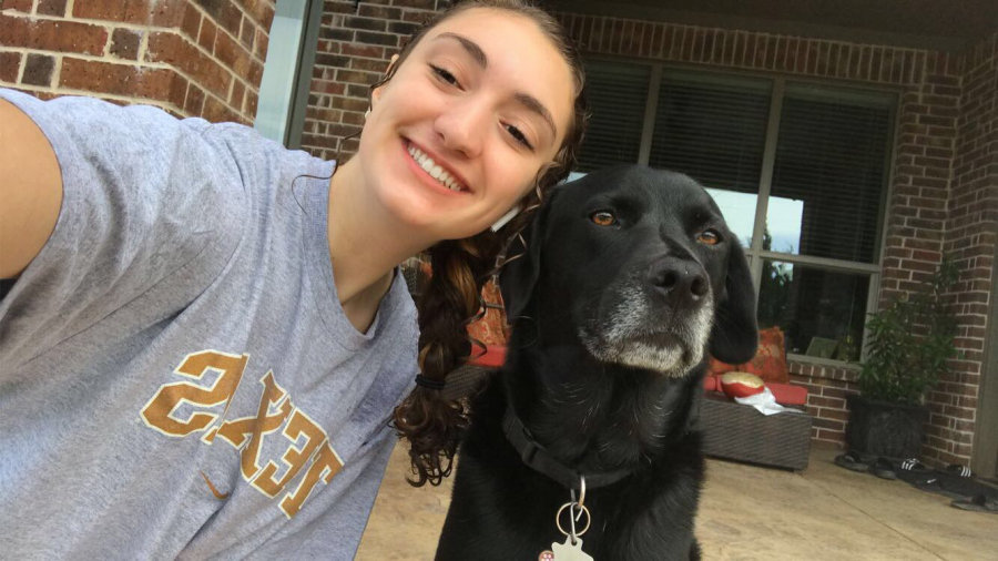 Doggie days \\ Elle, my 5-year-old black labrador mix, stops her playing in the backyard to take a picture with me, while in quarantine April 24. She is the life of this family. Being stuck at home has definitely made me realize her importance.