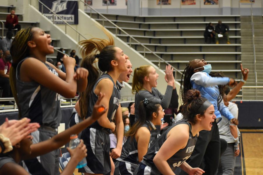Scream team \\ Jumping up off the bench, the girls varsity basketball team cheers for their teammate Aleena Dawkins as she scores, to tie up their game against Red Oak high school Feb. 22. The team won their playoff game in overtime 65-60 Feb. 26. 