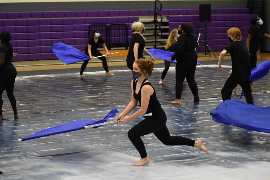 Rolling in the deep \\ Performing their show, freshman Alyson Sebastian dances and rolls on the performance mat with her flag Feb. 27. The JV Royals competed in their first competition of the season in Alvarado and won sixth place in the Regional A. 
