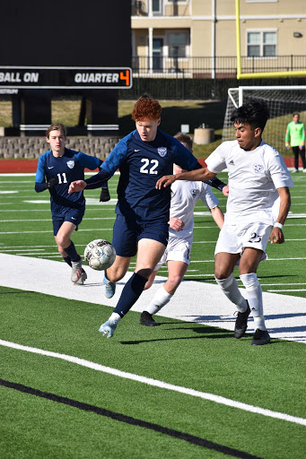 Sprinting springs \\ Taking the ball down the sideline, senior Garrett Geppert plays in the Wylie ISD Showcase Jan. 16 against the Sulphur Springs Wildcats. Varsity soccer fought hard, but ended in defeat 4-0.