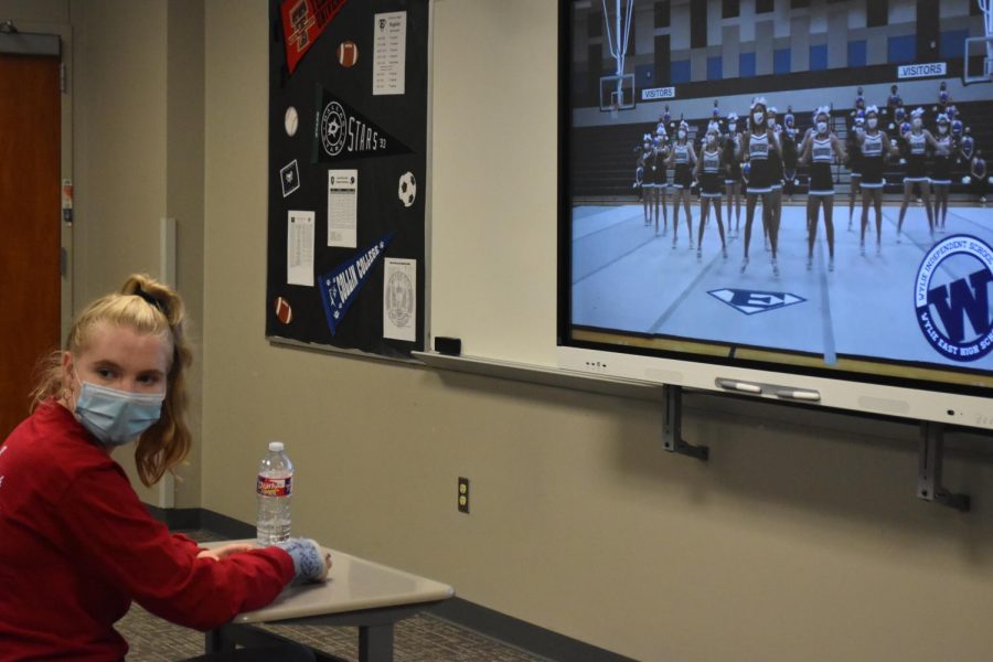 On screen spirit \\ Junior Brittany Erwin watches the pep rally in her second period class. Students took time out of their classes to join together in a safe and socially distanced fashion, to celebrate their school spirit for the first varsity football game.