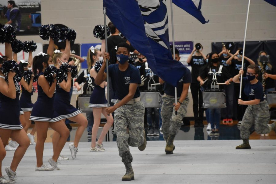 Putting on a performance  JROTC runs the Raider flags high and proud as the cheer team chants the Wylie East battle cry during the first ever virtual pep rally.
