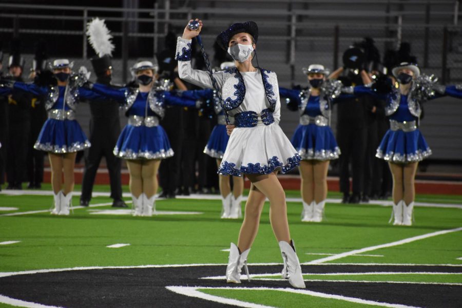 Strike a pose \\ In her signature officer pose, junior Hailey Gummelt leads the Sapphires at the Half Time Show Oct. 16. 