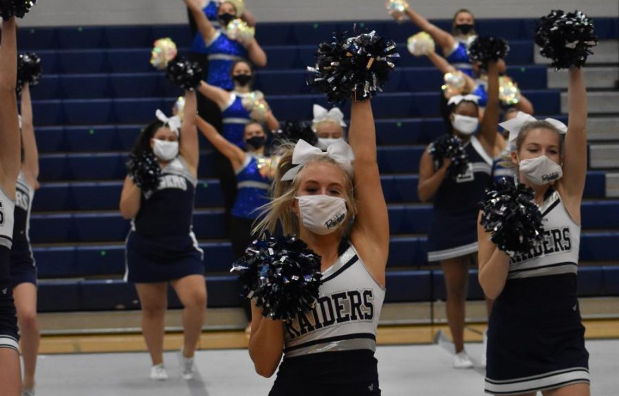 No contact \\ Junior Ashtyn Arp cheers during the filming of the virtual pep rally. To ensure she wont miss a cheer competition, Arp chose to move to remote learning. “I’m just glad I’m still able to go to practice and take care of the job I uphold on my team,”Arp said.