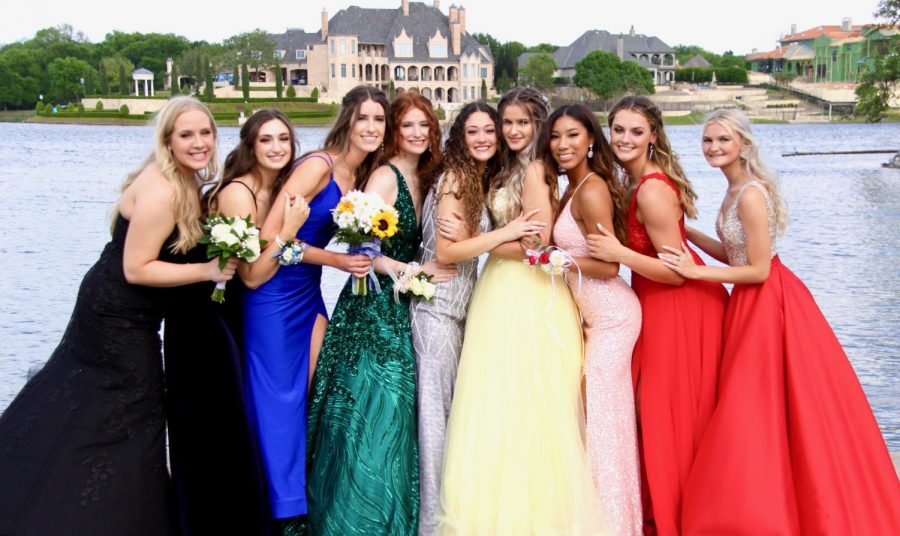 Girls night \\ Posing during their prom photos, a group of senior girls stand together in Adriatica Village May 8. Prom expenses are costly.