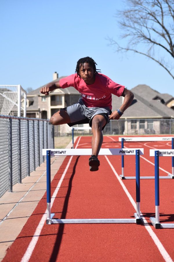 Over easy \\ Clearing the hurdle, junior Celdon Gooch practices to get ready for district. Gooch is on the varsity track team for hurdles and long jump. “I run track to get faster for football season,” Gooch said.