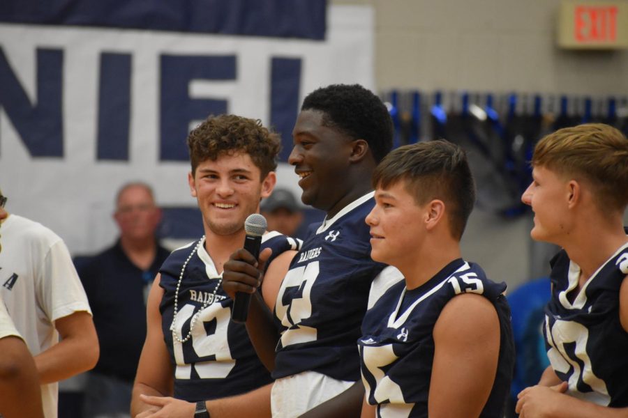 On your feet \\ Football captain Marcus Harbert leads the student body in a pep talk at the homecoming pep rally Sept. 3. “School spirit is the soul of the football team. The team is nothing without school spirit,” Harbert said.