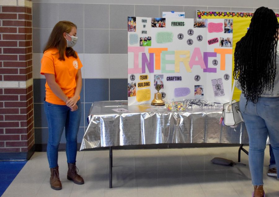 Interacting with students \\ During East Side Rally, clubs showcased their programs to students as they picked up their schedules and toured the school. Bailey Causey represents the Interact Club.