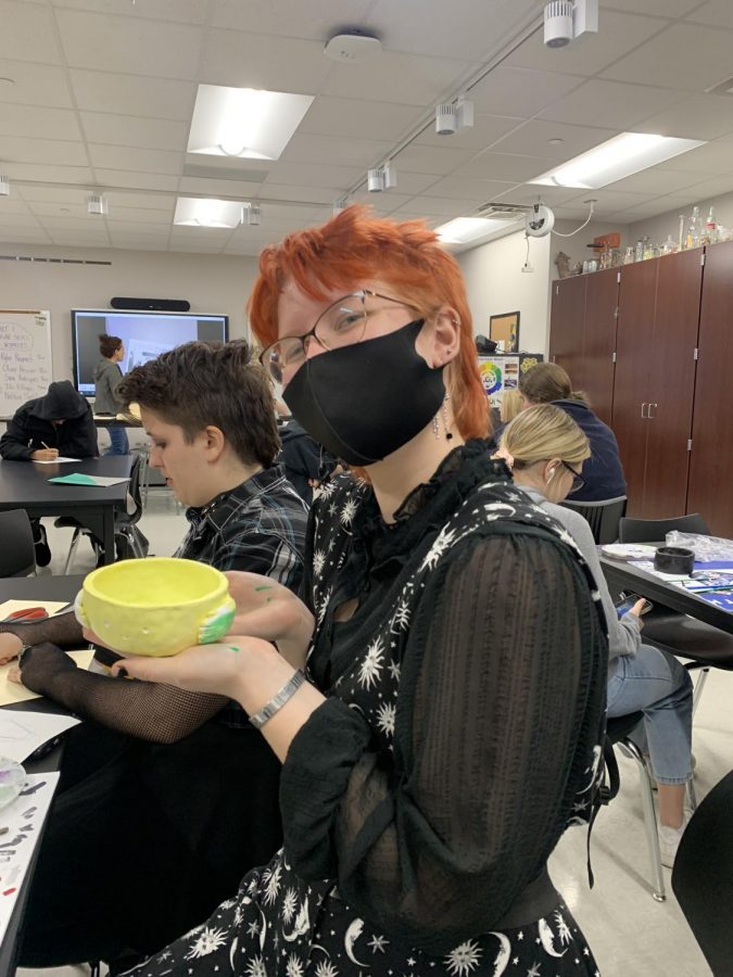 Pinching the pots \ Junior Ash Elgerash poses with her pinch pot she made in art class. “I’ve been drawing on my walls since I was two but I’ve been in an art class of some sort since I was 12,” Elgerash said.