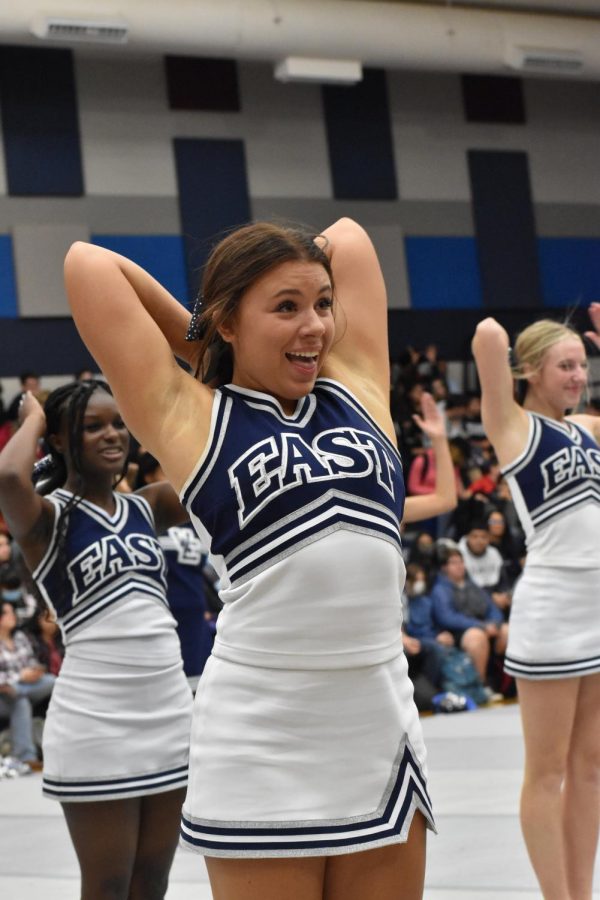 Behind+the+bow+%5C%5C+Cheering+with+her+team%2C+senior+Campbell+Andrews+performs+at+a+pep+rally+Oct.+21.+Andrews+is+the+captain+of+the+cheer+team+alongside+senior+Ashtyn+Arp.+%0A