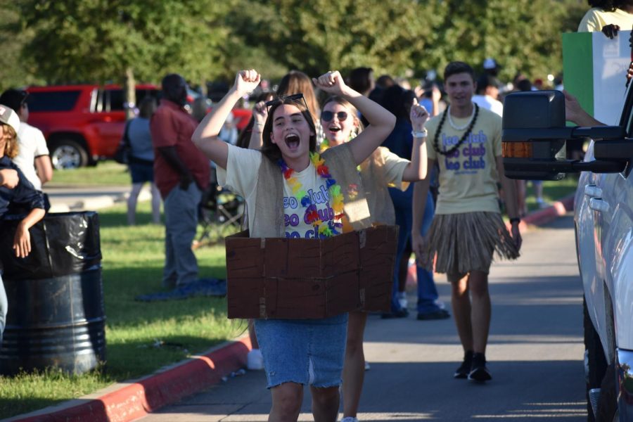 Leo Club member Avery Farris cheers as she marches with her clubs diversity themed float. I loved seeing everyone in the community involved and together again after being separated so long because of COVID-19, Farris said. 