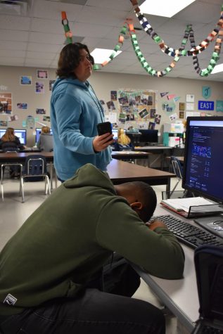 Sneaky snapshot \\ Capturing the moment, junior Zack Dorsey takes a picture of fellow classmate, senior TJ Garvin, “sleeping” in class.
