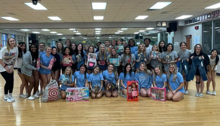 Spreading Christmas cheer \ Beaming with their successful target haul, the cheerleaders reveal the tags they purchased for the Wylie Way Christmas and Holidays event. “It’s a really rewarding feeling to give back and know that you're the reason a kid will get to open a present,” head varsity cheerleader Campbell Andrews said.
