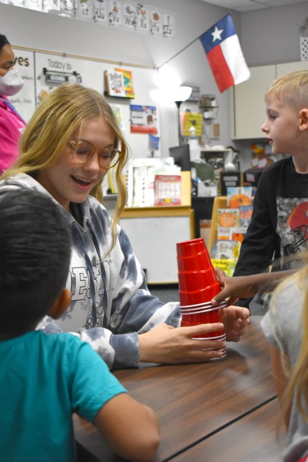 Count on it \\ Teaching kindergarten students how to subtract, Freshman Amiah Leiker uses plastic cups to help the kids visually. “We would stack the cups in a tower and talk about how many would be left if I took a certain amount away,” Leiker said. 
