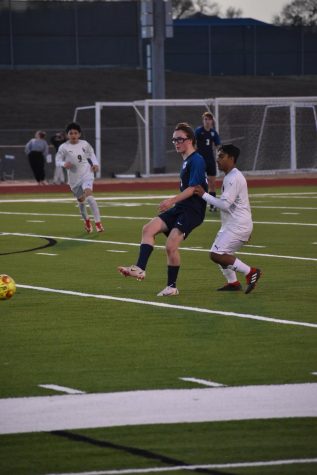 Kicking it up a notch \\ Passing the ball, sophomore Maguire Morton plays in the JV soccer game against Lake Dallas. JV beat Lake Dallas 3-1 Jan. 18. 
