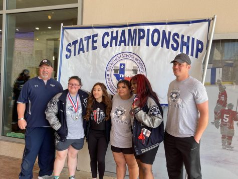 Great at state \\ Powerlifters and their coaches pose for a photo at the state competition. Junior Carmen Mitchell placed first and senior Nyliah White received a fifth place title. “I have been powerlifting since freshman year, but I have grown up around the sport,” Mitchell said.