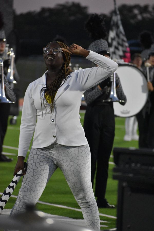 Pose \\ Striking a pose for the end of this years marching band show Re:Imagine, senior Obosa Odia looks out to the audience and drum major to wait for her cue to start the next movement.