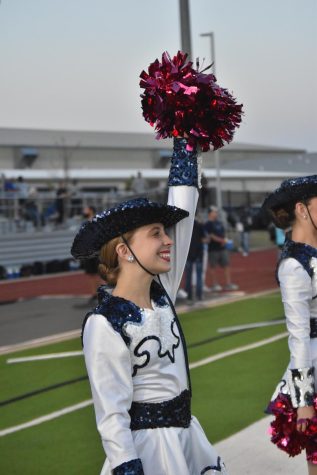 Before the football players run out of the tunnel, junior Ellie Eason dances in a victory line. getting to be apart of when the players run out on the field is one of my favorite parts, Eason said. Raiders defeated Wylie High 26-19. 