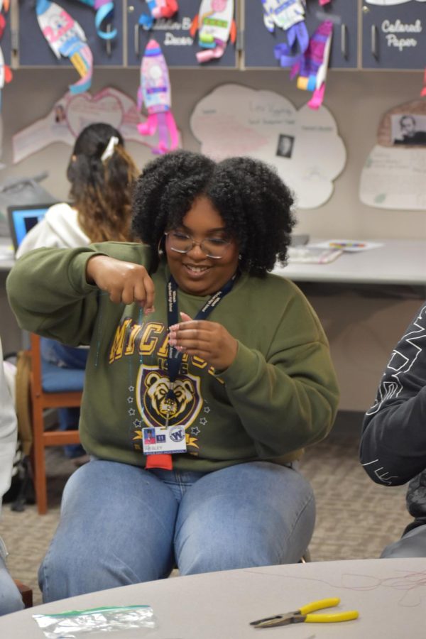 Having fun, Junior Ava Wesley is getting the tinsel ready to put in her hair. I love how I got to do multiple exciting assignments and things I have never done before, Wesley said. 