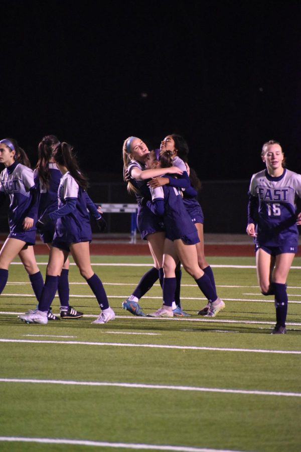 Having a group hug, Juniors Raegan Hollis and Bryn Geppert share an embrace during their soccer game. Im most looking forward to seeing what this team can do in the playoffs this year, Geppert said.