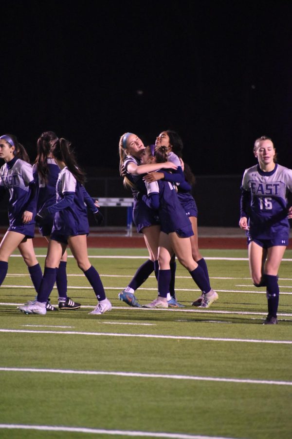 Having a group hug, Juniors Raegan Hollis and Bryn Geppert share an embrace during their soccer game. "I'm most looking forward to seeing what this team can do in the playoffs this year," Geppert said.