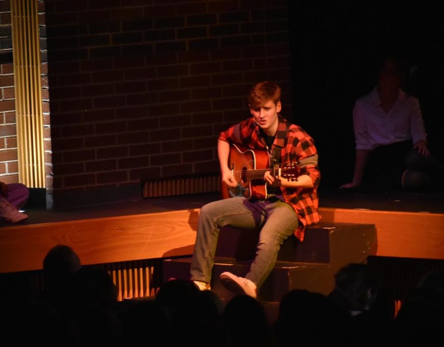 My wonder walker \ Bringing down the mood with a heartfelt ballad and gentle guitar strums, sophomore Henry Walker performs “Wonder Wall” at the annual Pop Show May. 5. “Performing in front of an audience is pretty nerve-wracking, but once you’re on stage, your nerves begin to melt away,” Walker said. 