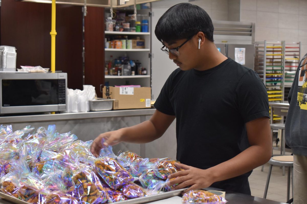 Autumn delights  Making final touches, culinary student Jordan Truong organizes the goodie bags the advanced culinary arts class would sell at the theaters production of the musical Grease Oct. 19 and Oct 21. The students chefs work continuously throughout the school year to cater meals for various school activities. 