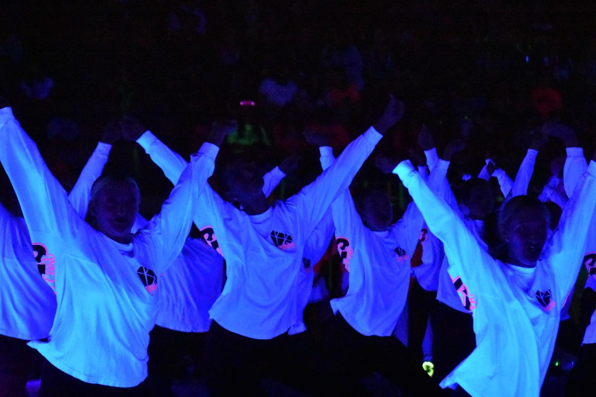 Let’s Glow // Drill team performs their routine during the pep rally. The team wore neon colors that glowed with the lights off. “My favorite part about drill team is the feeling you get when you perform,” junior Camryn Carpenter said. “It is so much fun getting to do what I love in front of people.”
